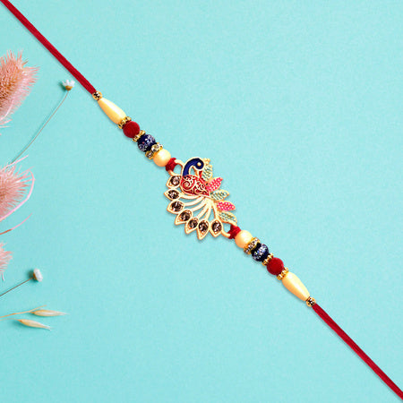 Colorful Peacock Rakhi With Stone Detailing And Red Thread