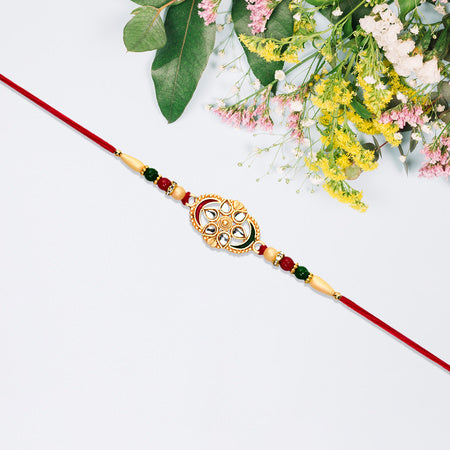 Traditional Oval Rakhi With Kundan Work And Red-green Beads